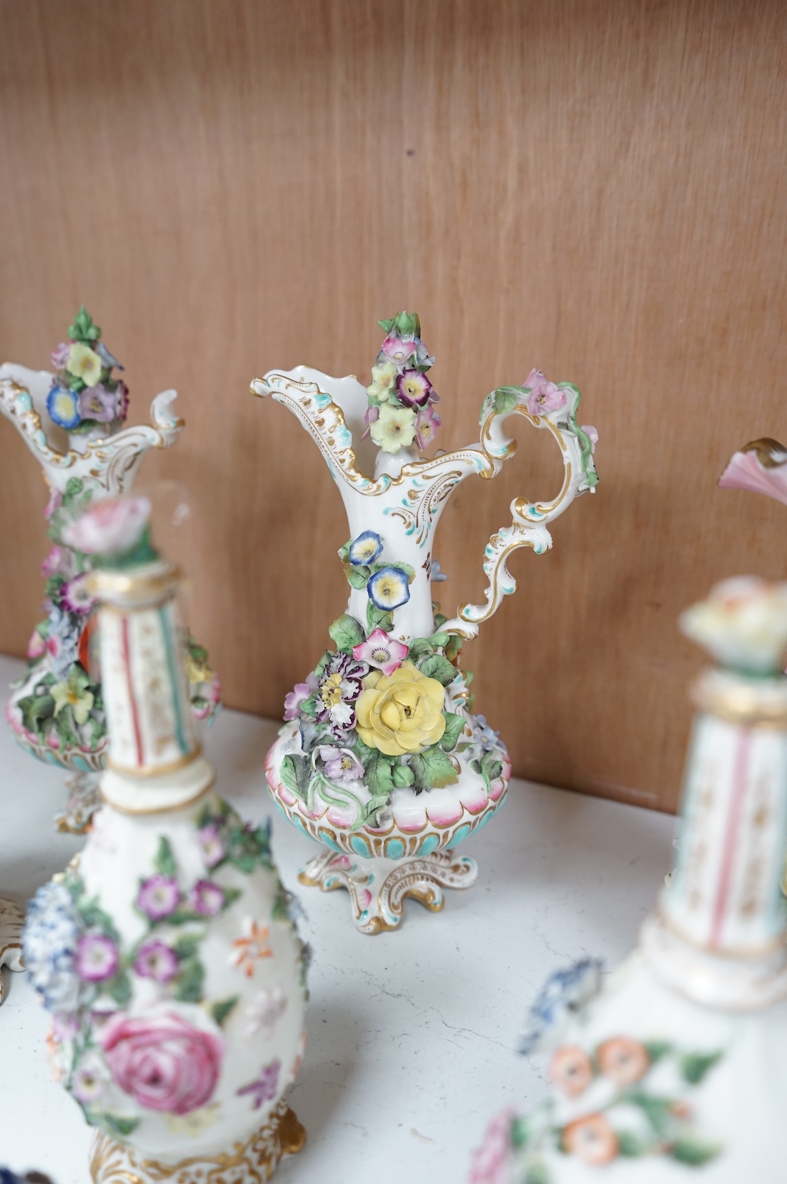 A group of English porcelain flower encrusted scent bottles and yours, Coalport, Minton etc., c.1830-50 together with Continental porcelain figures a wall pocket etc, largest 26cm high